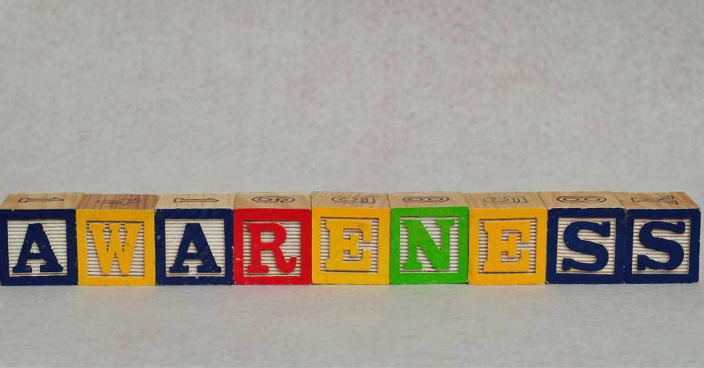 colorful alphabet letter blocks lined up to spell the word AWARENESS