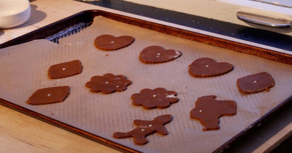 old fashioned gingerbread cut out cookies on baking sheet lined with parchment paper read to bake