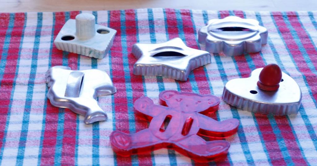 Retro cookie cutters on tea towel for making old fashioned gingerbread cut out cookies