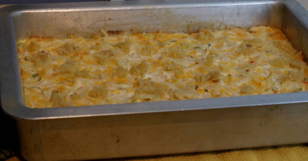 Pan of freshly baked cheesy potatoes golden browned.
